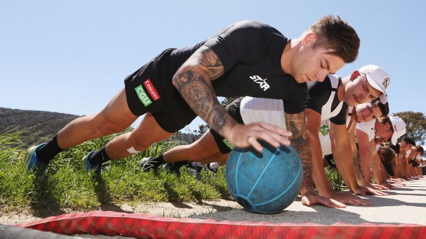 On the ball: Jamie Elliott works on his core strength at Falls Creek