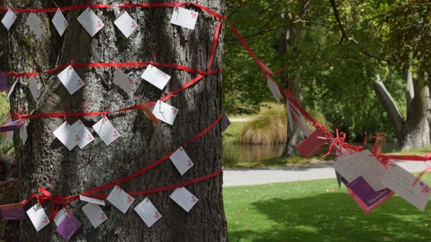 Messages are left on a tree after a memorial service held on Monday in Christchurch's Botanical Gardens for victims of the 2011 earthquake.