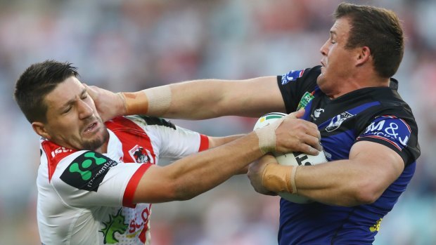 Don't argue: Josh Morris fends off Gareth Widdop during the Bulldogs' emphatic victory. 