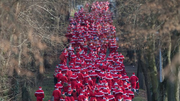 Runners in Santa Claus costumes participate in the traditional Saint Nicholas Run in Michendorf, eastern Germany, on Sunday.