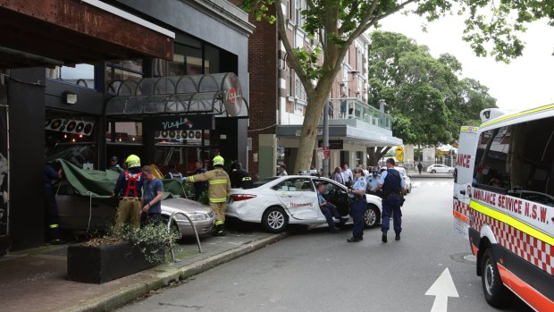The Toyota Camry first hit a taxi before ploughing into Vinyl Cafe in Newcastle and trapping a mother and baby.