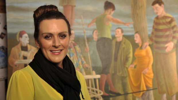 Museum curator Bianca Acimovic pictured with the oil on canvas work Saltimbanques 2007 by Australian artist Graeme Drendel.