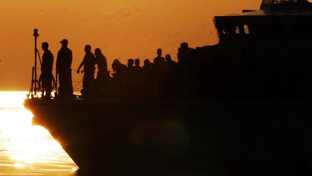 Syrian refugees stand on the Frontex patrol boat while they are escorted aboard the Eleftherios Venizelos.