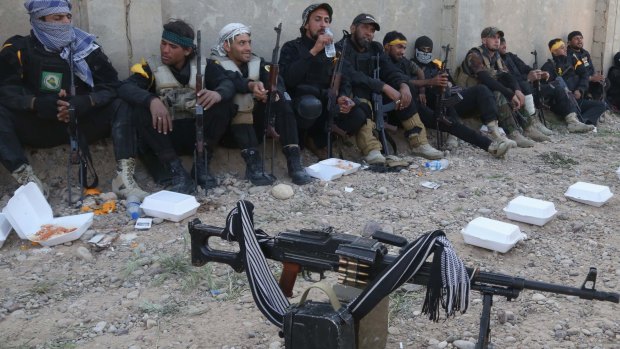 Iraqi Shi'ite militants rest near the front line with Islamic State in Tikrit.