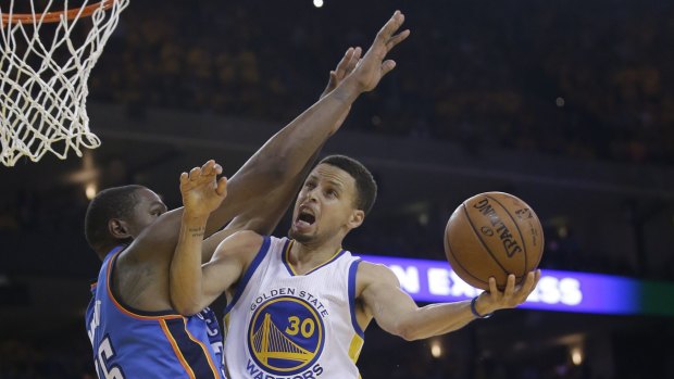 Back in form: Golden State Warriors star Stephen Curry (30) drives to the basket as Oklahoma City Thunder's Kevin Durant defends.