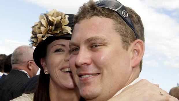Trainer Trent Busuttin is congratulated by his wife Natalie after jockey Hugh Bowman rode Sangster to victory in the 2011 Victoria Derby.
