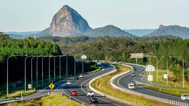 The Bruce Highway, looking south past Mount Tibrogargan in the Glasshouse Mountains, in Queensland. A fabulous road trip in Australia can be done as cheaply as an overseas holiday, writes one reader..