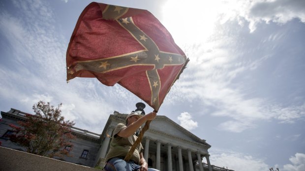 John McCaskill waves a Confederate battle flag he has owned for three decades, on the steps of the State House in Columbia, South Carolina, July 9, 2015. After hours of emotional debate, legislators voted early that day to stop flying the flag on the grounds of the State Capitol.