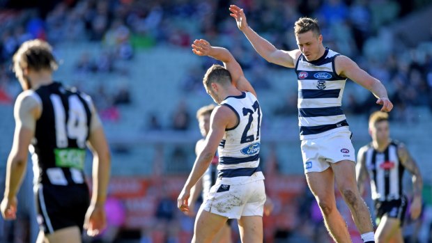 We'll take it: Mitch Duncan and Sam Menegola celebrate the Cats' win.