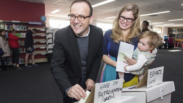 Greens Federal member for Melbourne Adam Bandt casts his vote, with his wife Claudia Perkins and daughter Wren. 