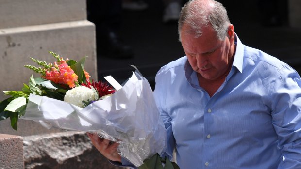 Lord mayor Robert Doyle lays flowers in the Bourke Street Mall.