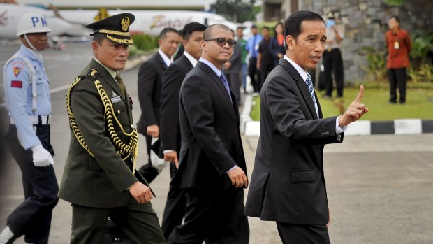 Indonesian President Joko Widodo, right, returns from the ASEAN summit in Malaysia on Monday.