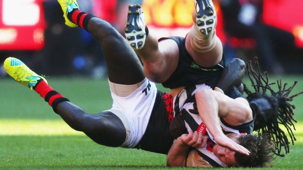 Anthony McDonald-Tipungwuti of the Bombers takes Taylor Adams of the Magpies to ground.