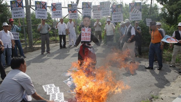South Korean conservative protesters burn a effigy of North Korean leader Kim Jong-Un and flag during a anti-North Korea rally near the demilitarised zone at Imjingak on Tuesday.