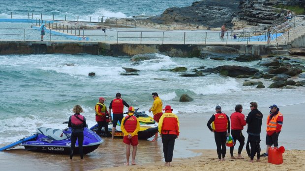 Surf Life savers and rescue prepare to enter the water in the search at Curl Curl Beach.