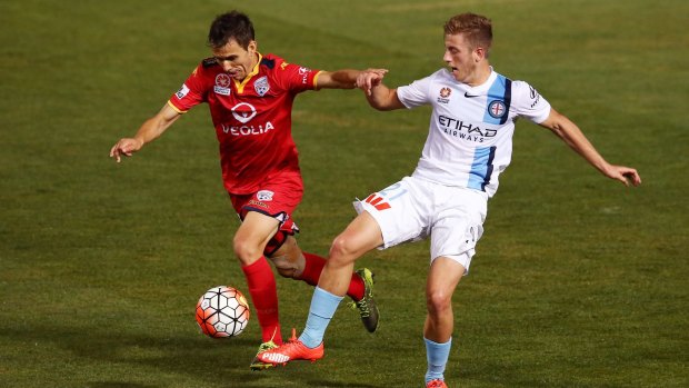 Isaas of Adelaide United battles with City's Stefan Mauk last month.