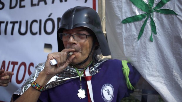A supporter of the legalisation of marijuana smokes outside the Supreme Court in Mexico City on Wednesday.