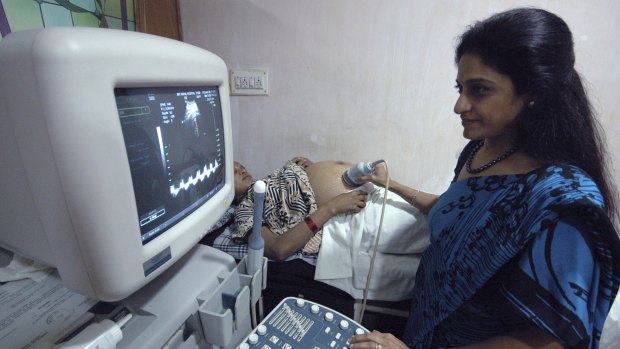 Surrogacy pioneer Dr Nayna Patel examines a surrogate mother at Kaival Hospital in Anand, India, in 2007.
