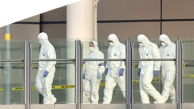 Police forensic officers leave the Manchester Arena on Tuesday morning as they investigate the scene of an explosion.