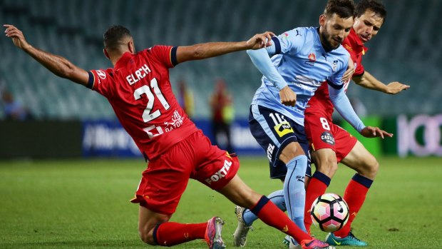 Sliding tackle: Milos Ninkovic is challenged by Tarek Elrich and Isaias at Allianz Stadium.