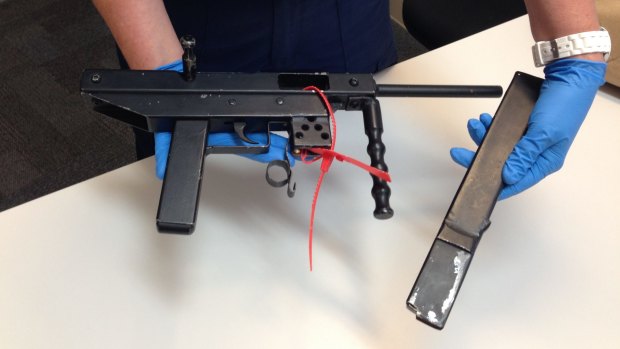 Police display an allegedly stolen weapon seized in Warnbro.