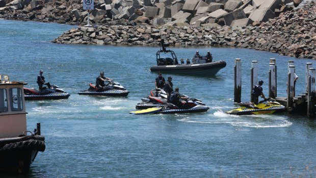 Police set our on jet skis as the BBC Shanghai arrives in Port Kembla Harbour.