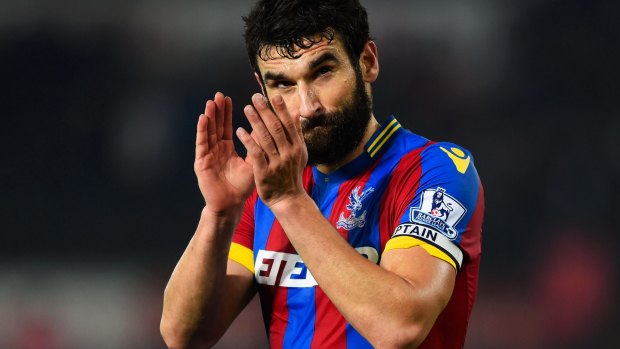 Emotional: Soccceroos captain Mile Jedinak laid a cricket bat out on the field in tribute to Phillip Hughes before Crystal Palace's draw at Swansea.