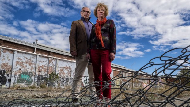 Helen Halliday and former Port Phillip councillor David Brand, from the Fishermans Bend Network group, outside contaminated land in South Melbourne. They want better planning for the new area.