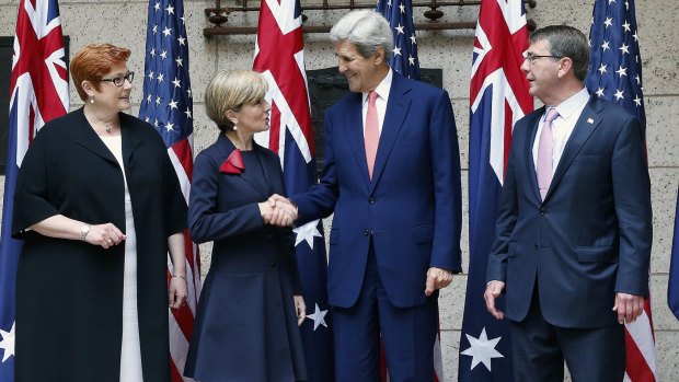 US Secretary of State John Kerry shakes hands with Australian Foreign Minister Julie Bishop, left, with Defence Secretary Ash Carter, right, and Australian Defence Minister Marise Payne, left, in Boston on Tuesday. 