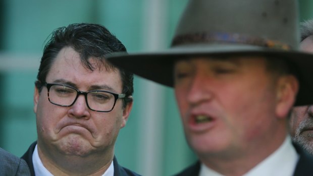 Nationals MP George Christensen listens to Barnaby Joyce during a press conference. 