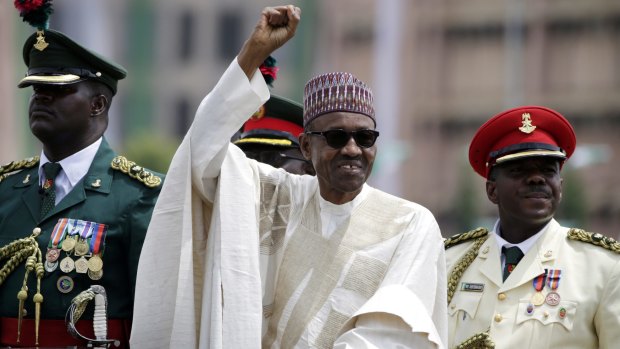Nigerian President Muhammadu Buhari salutes his supporters during his Inauguration in Abuja, Nigeria, in May.