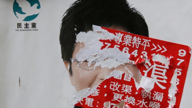 An election campaign poster for pro-democracy candidate Helena Wong Pik-wan is seen defaced by a sticker days before legislative elections, in Hong Kong.