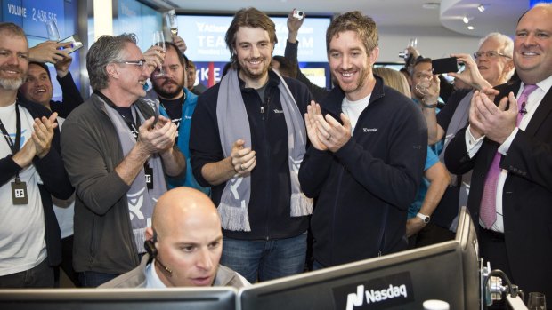 UNSW graduates and Atlassian co founders Mike Cannon-Brookes (left, with scarf) and Scott Farquhar watch as shares open on the Nasdaq.  