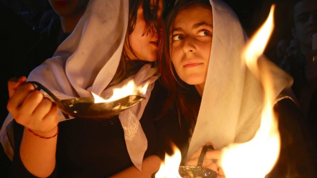 Yazidi women hold fires during celebrations of their new year at Lalish, Iraq, in April 2015.