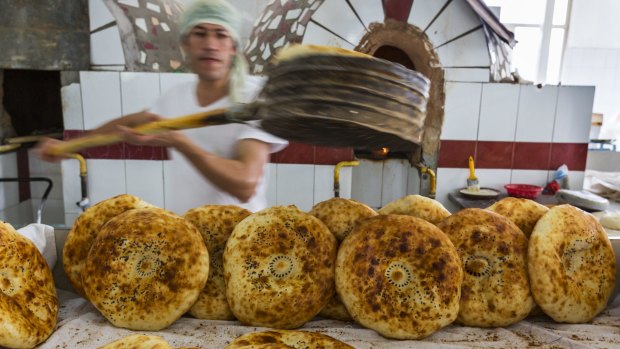  A man makes bread in the Chorsu Bazaar in Tashkent, Uzbekistan. 
