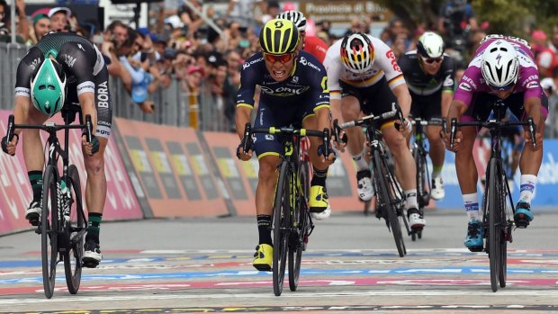 Caleb Ewan, centre, crosses the line to win the seventh stage of the 100th Giro d'Italia.