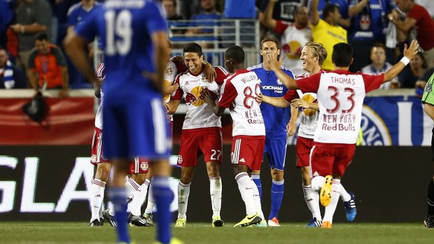 Upset: New York Red Bulls midfielder Sean Davis is congratulated by teammates after scoring the first of his two goals in the second half against Chelsea FC in Harrison.