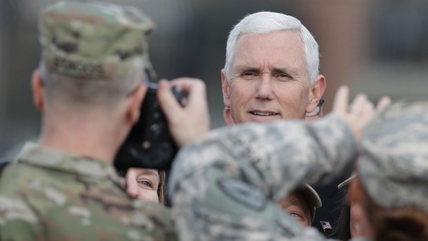Vice-President-elect Mike Pence poses for photos after speaking at a Veterans Day ceremony.