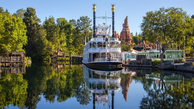 The Mark Twain Riverboat and Big Thunder Mountain in Frontierland at Disneyland Park in Anaheim, California.