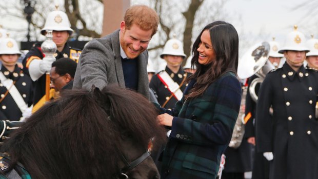 Prince Harry and Meghan Markle meet a Shetland Pony at Edinburgh Castle in Scotland.