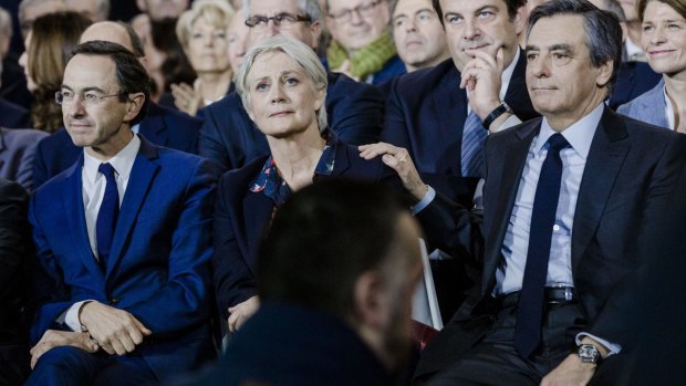 Francois Fillon, France's presidential candidate, right, puts a hand on the shoulder of his wife, Penelope Fillon, in Paris.