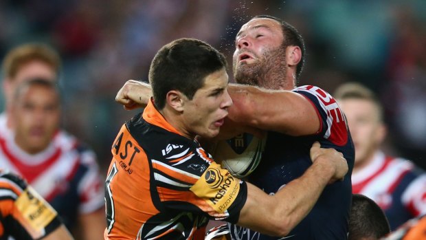 Body line: Wests Tigers' Mitchell Moses (left) does his best to hold back the Rosters' Boyd Cordner.