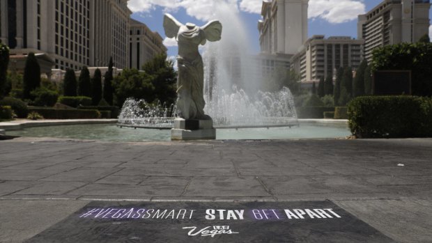 A social distancing sign in front Caesars Palace.