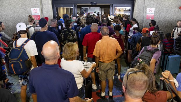 Passengers wait for terminals to reopen at Fort Lauderdale-Hollywood International Airport after officials received a bomb threat on Saturday.