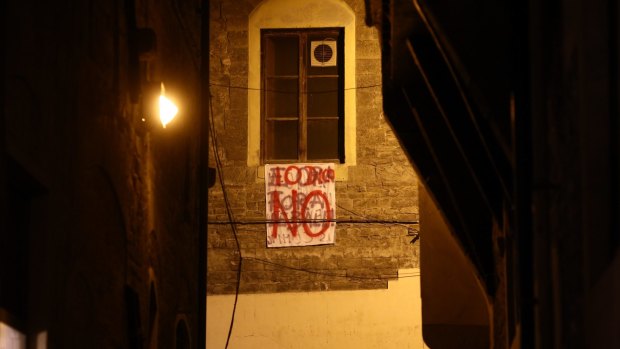 A 'No' banner hangs from a window close to Piazza della Signoria in Florence, Italy.