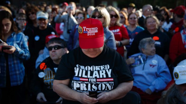 A Trump supporter wears a 'Crooked Hillary for prison' T-shirt  at a rally at Regent University, Virginia Beach.