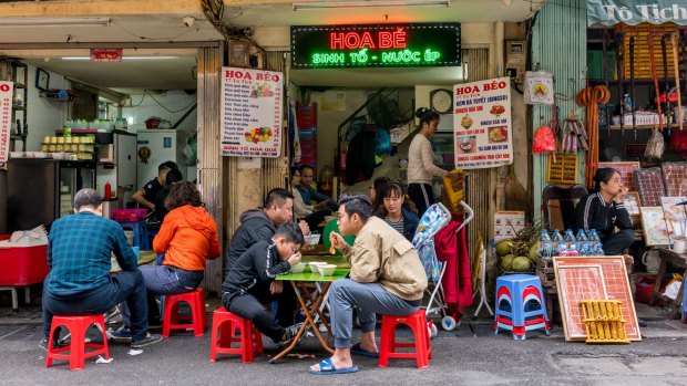 Locals eat at restaurant in Hanoi old town.