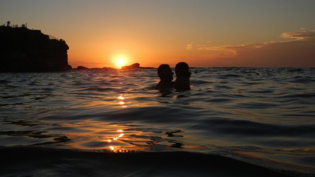 Sydney swelters through another night, as swimmers hit the beach just after 6am.