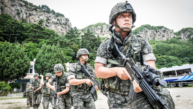 South Korean Marines patrol along the coast of the eastern island of Ulleung, South Korea, on Saturday as part of the largest-ever training to defend the island.