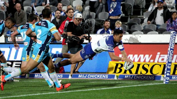 On a wing and a prayer: Curtis Rona scores a try against the Gold Coast Titans at Central Coast Stadium.